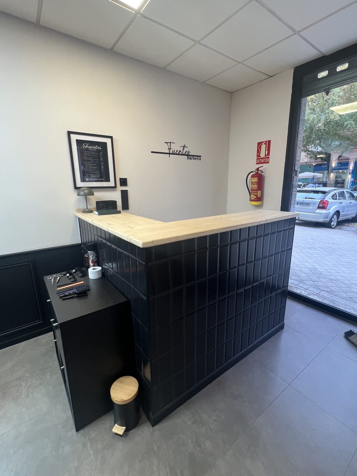 Mostrador de recepción con el rótulo de Fuentes Barbería